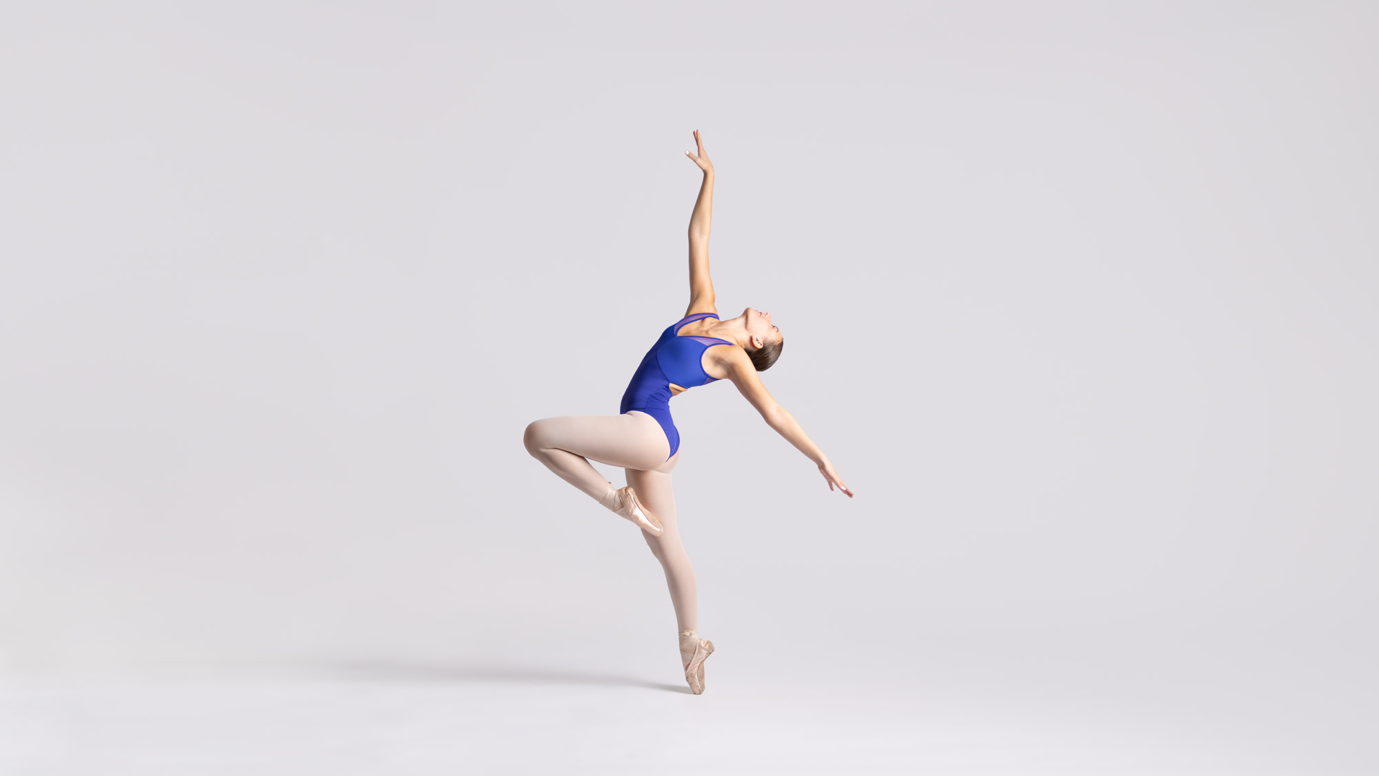 Dancer performing on a dark stage at a dance competition